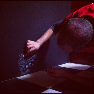 The artist at work. (Okay, I now totally love the chalkboard wall.)