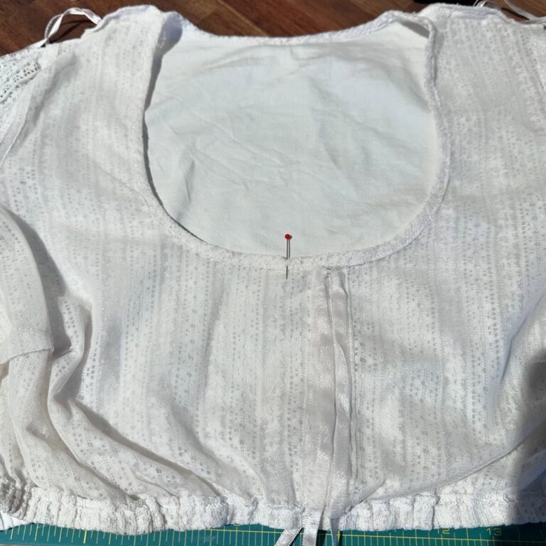 Very important and delicate mending complete! My lace dirndl blouse has a channel for a ribbon at the front so you can adjust the amount of décolletage you wish to display. However, mine was off-center and it always annoyed me. So today I *very carefully* unpicked the gauze, moved it, and reattached. It worked! #oktoberfestpreparation 🪡 🧵