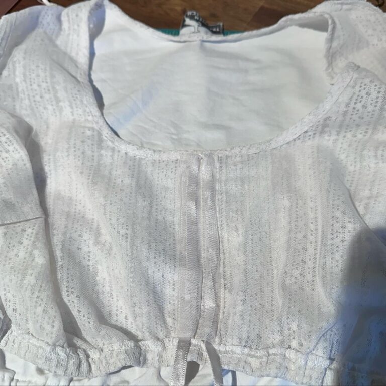 Very important and delicate mending complete! My lace dirndl blouse has a channel for a ribbon at the front so you can adjust the amount of décolletage you wish to display. However, mine was off-center and it always annoyed me. So today I *very carefully* unpicked the gauze, moved it, and reattached. It worked! #oktoberfestpreparation 🪡 🧵
