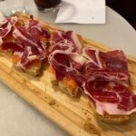 We had a private food tour tonight around the Malasaña neighbourhood of Madrid with Margit from @walkandeatspain, and it honestly felt like an evening catching up with an old friend. She took us to her favorite places for cheese, tapas, vermouth, beer, and wine, and it was all excellent. ❤️ (1/2)
