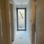 Week 15: We’re still overseas, but work has continued on the house – and we’re thrilled to see the new windows and doors are in place! Double glazing is going to make next winter a lot more bearable. 🥶 And look at the natural light we get in the back hallway now! All the rendering is done, and the builder and designer are finishing off the reveal details. We’re in the home stretch… ❤️🪟🏠 #renovation