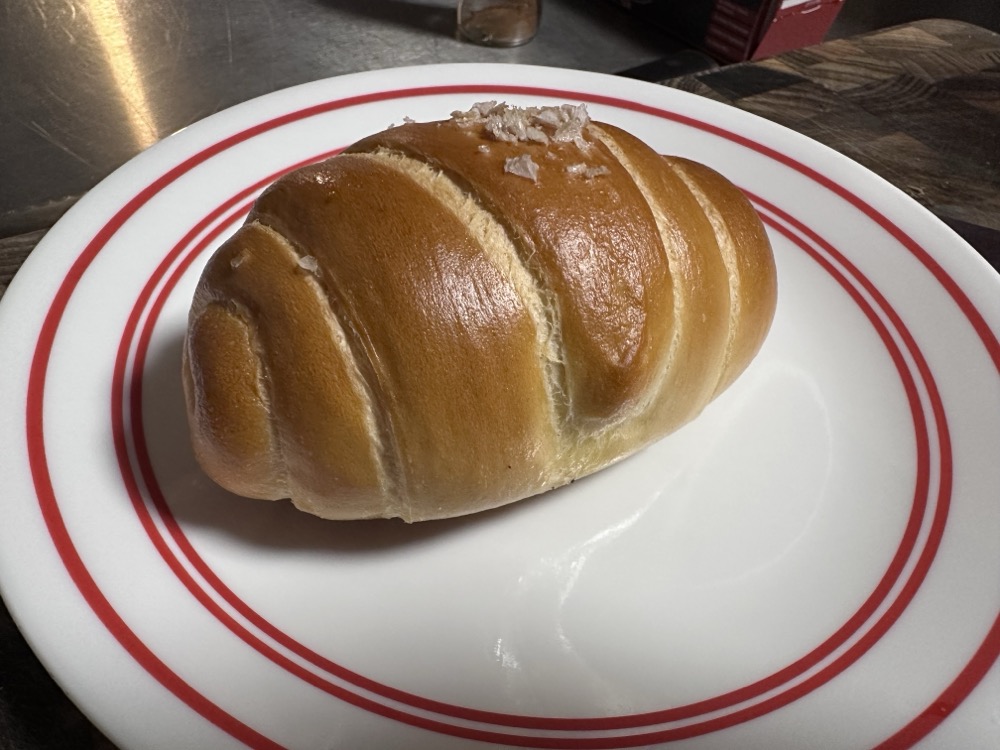 A plain salt bread, which looks like a fat croissant crossed with a dinner roll