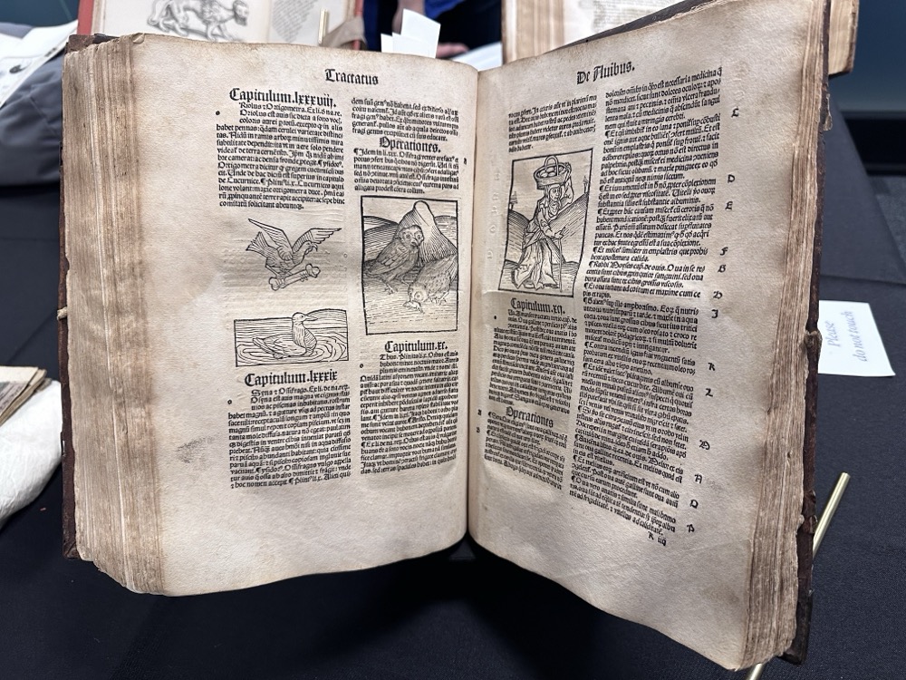 A very old book written in Latin with descriptions and pictures of animals and plants