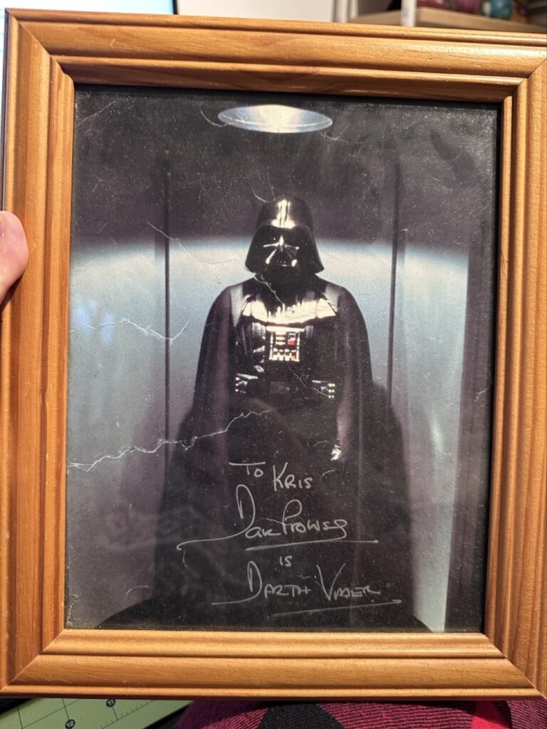 An autographed photo of Darth Vader that says:
To Kris
Dave Prowse
is
Darth Vader