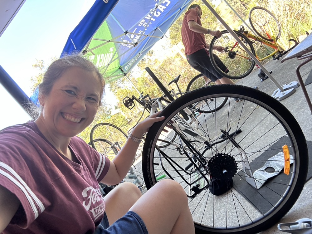 A woman holding a bicycle tire