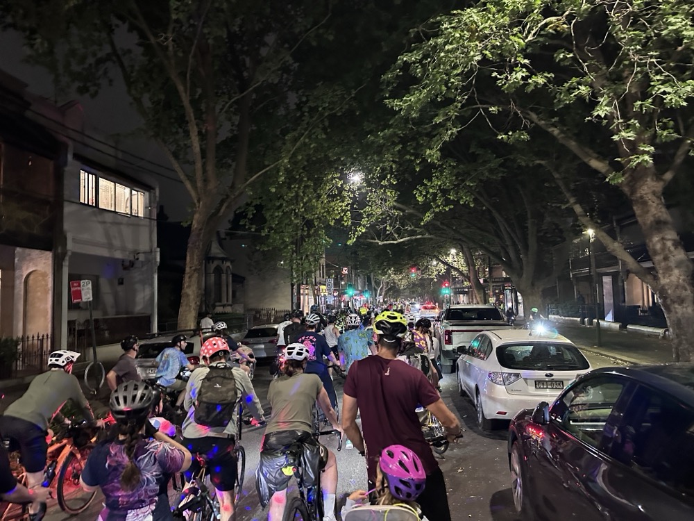 The view of a huge group bike ride at night