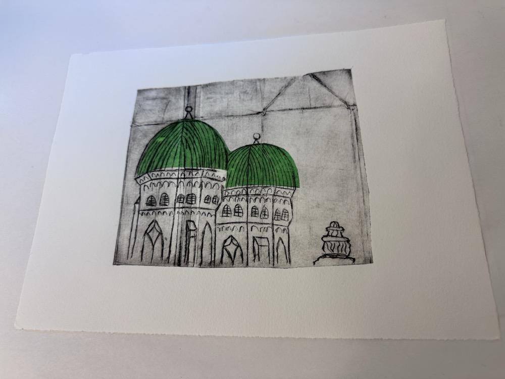 A print of a rough sketch of the Frauenkirche in Munich, with green tissue paper for the domes